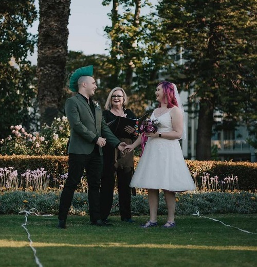 Az and Nikki smiling, being married by Jenny from Encompass Ceremonies.