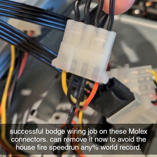 A close up of a Molex connector plug but instead of being connected to a Molex adaptor there are four black insulated wires that have been inserted into the receptacles in the plug. No exposed wires are visible. A Snapchat text bar says “successful bodge wiring job on these Molex connectors. can remove it now to avoid the house fire speedrun any percent world record”